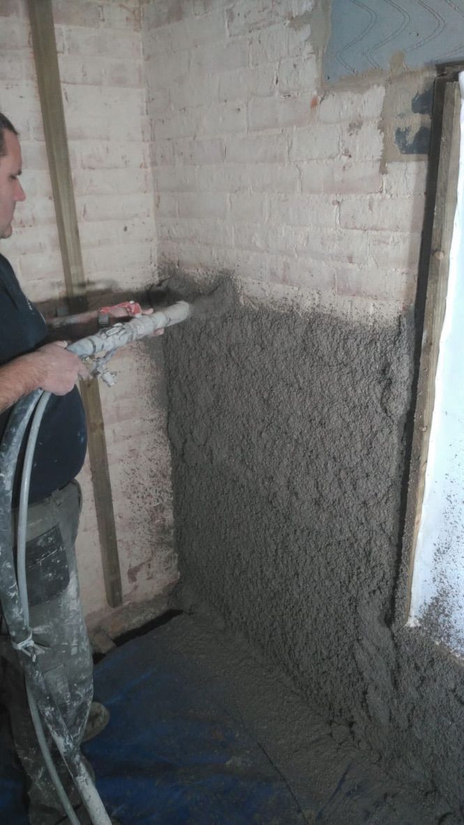 Diathonite being sprayed onto a brick wall