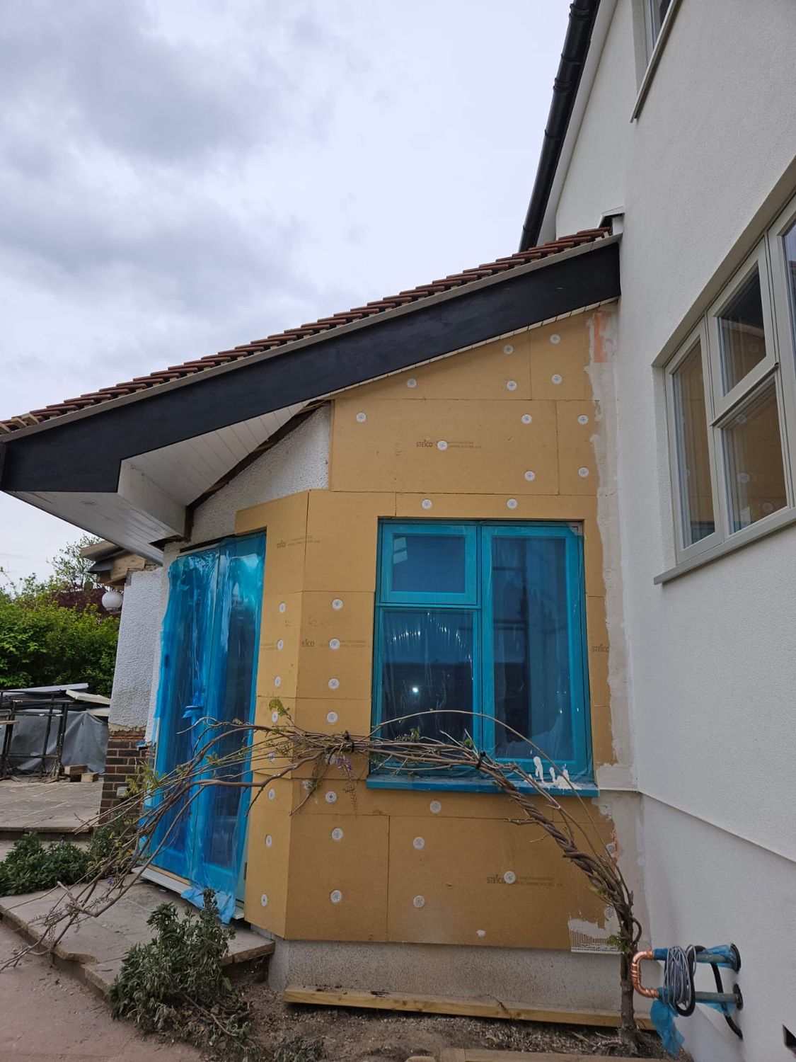 Wood fibre boards fixed to the outside wall, before rendering