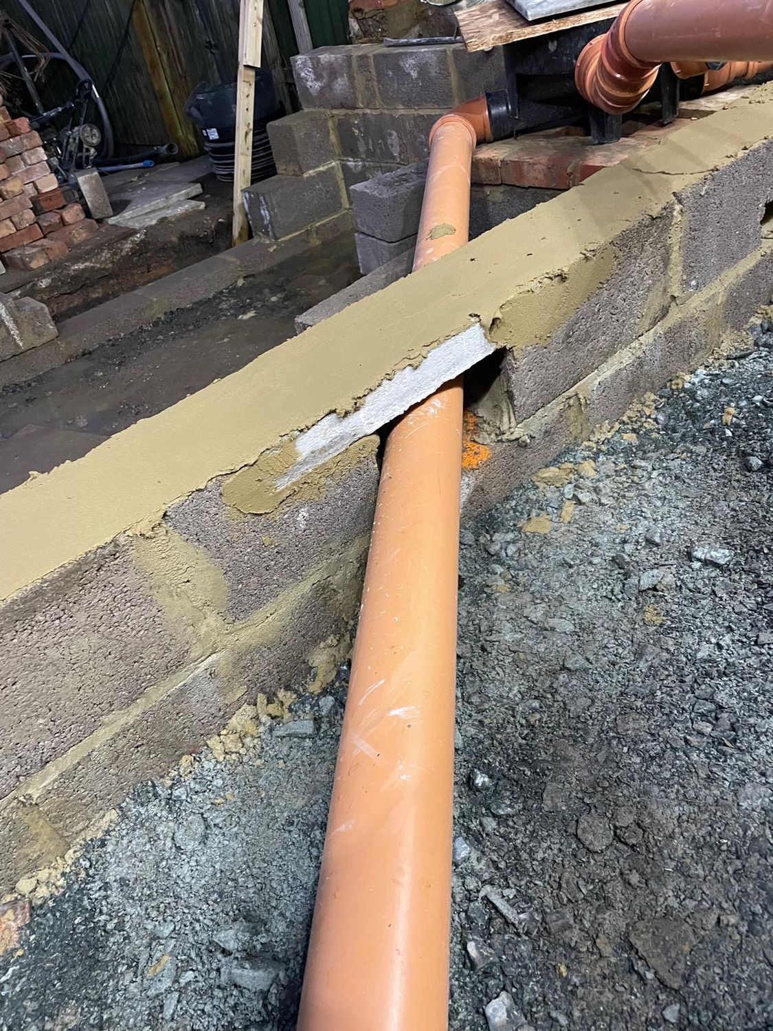 Blockwork below DPC and moving the manhole, rebuilding drainage for extension