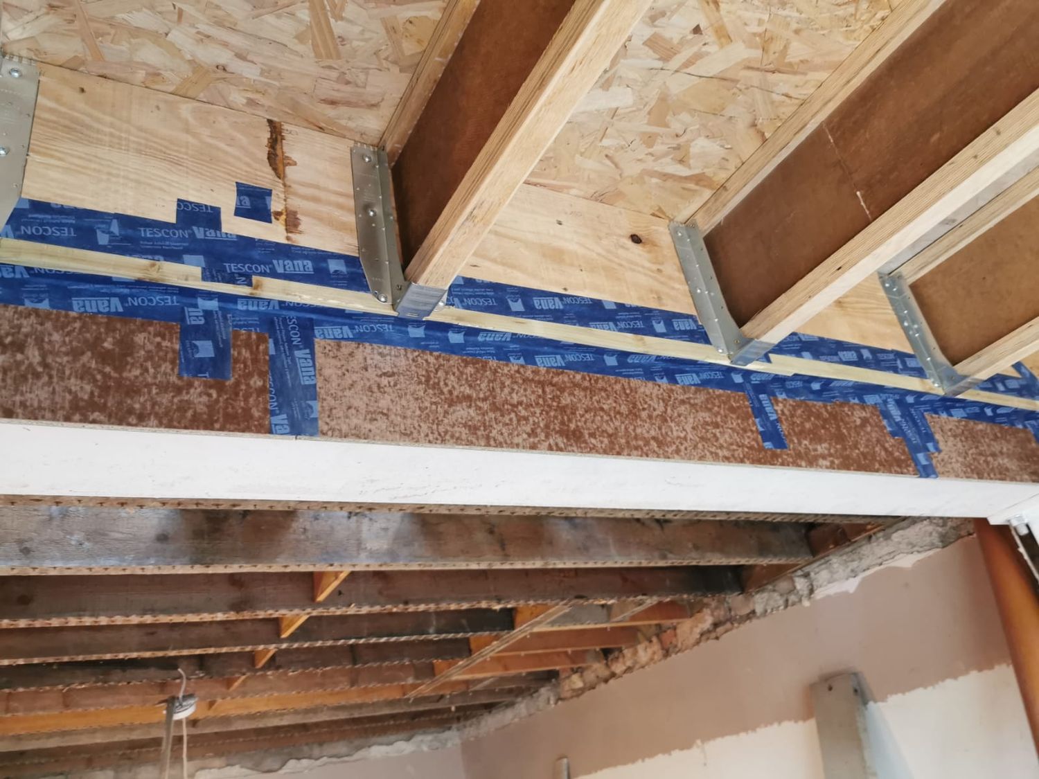 Airtightness work as the extension roof joins the existing building