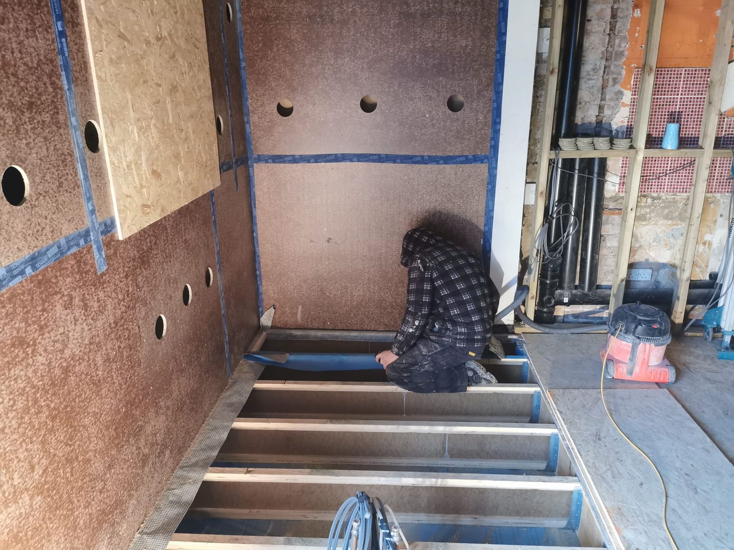 Preparation works for blowing Warmcel cellulose insulation into new extension floor structure