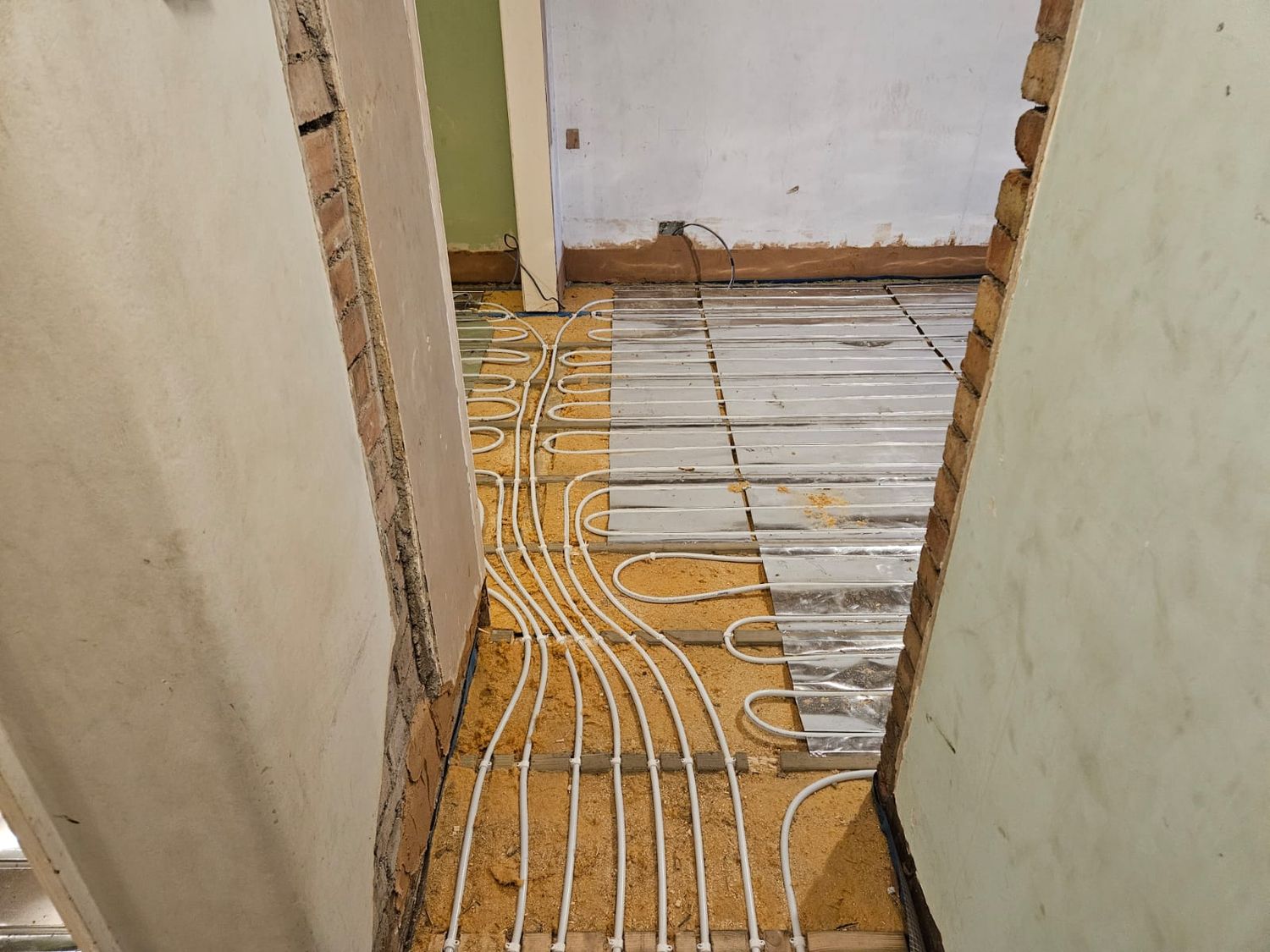 Underfloor heating runs from manifold to rooms