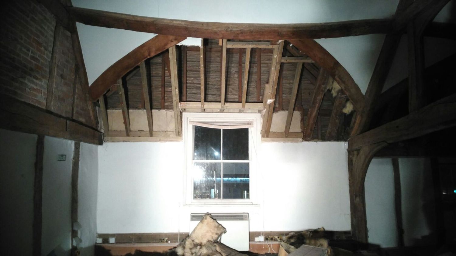 Old, inefficient insulation taken down, revealing 16th century oak frame roof