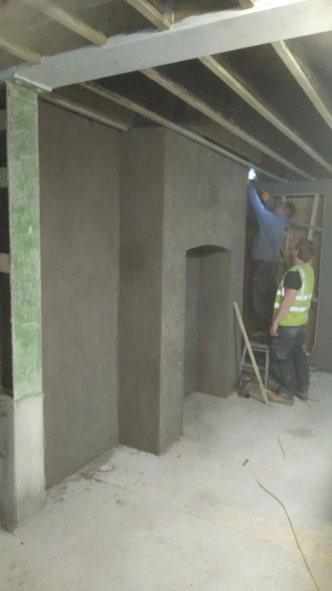 Diathonite Evolution lime-cork-clay plaster being applied in front room