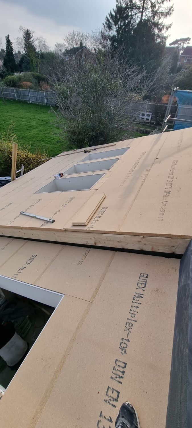 Roof insulation with Gutex woodfibre sarking board on the top of roof rafters and flexible insulation