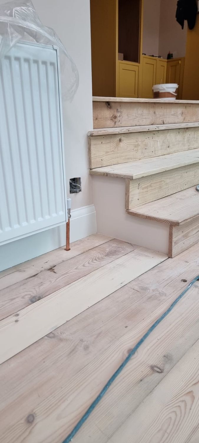 Internal refurbishment after insulation works, joinery, steps installed, timber floor sanded