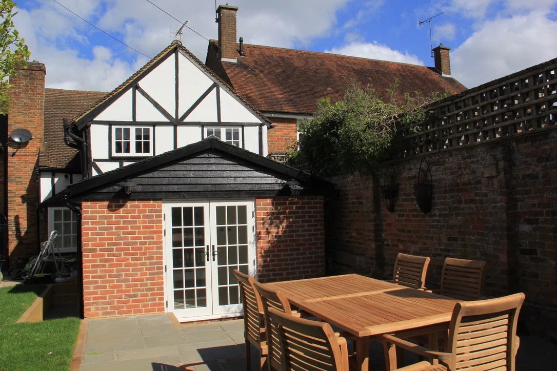 Timber-frame extension with blown cellulose insulation with conservation-approved external detailing