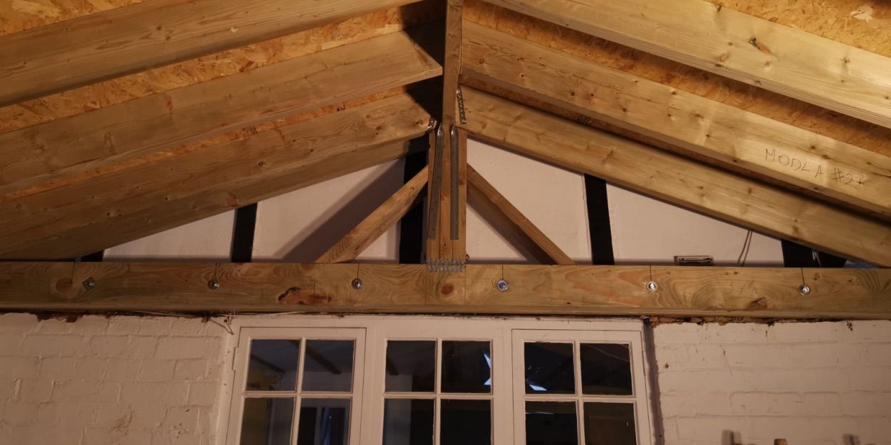 Timber frame roof structure being installed