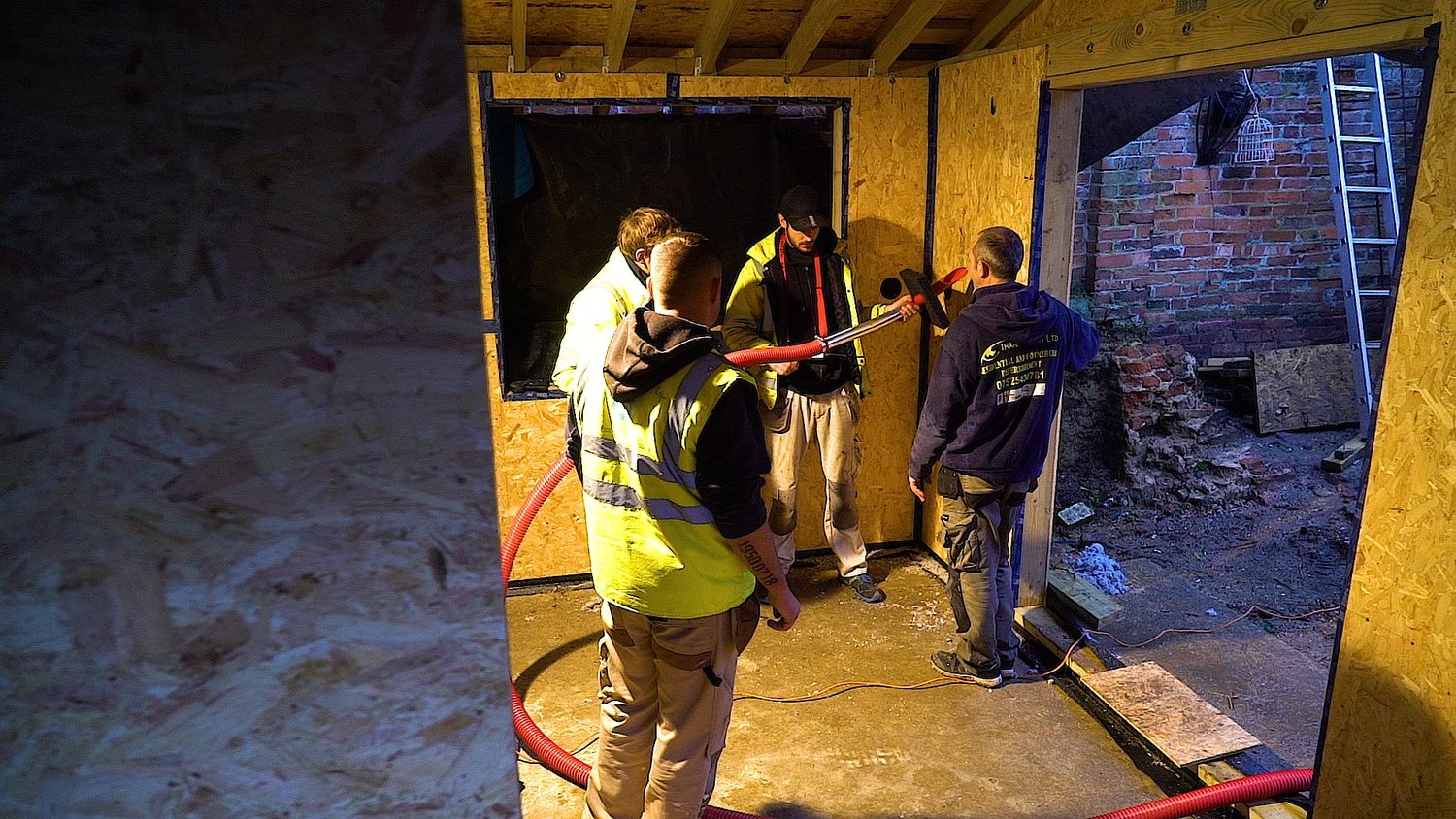 Warmcel cellulose fibre insulation being blown into timber structure in St Albans extension
