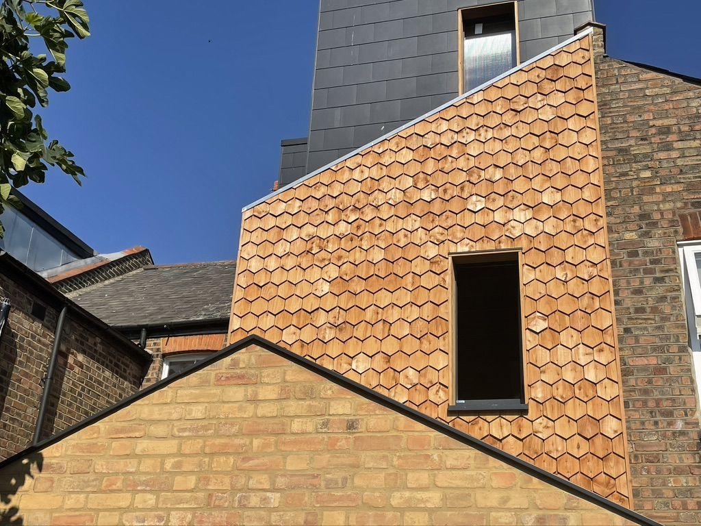 Highly insulated loft conversion and extension, lot of airtightness work and a very unusual EWI with unusual timber cladding