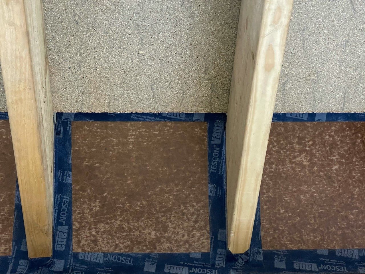Airtightness taping at roof wall junction with airtightness board and Pro Clima Tescon Vana tape around