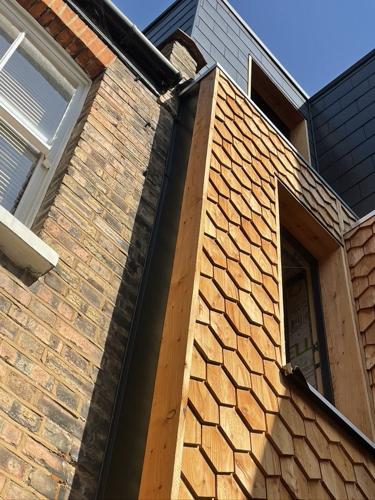Completed cedar wood shingle cladding on external wall insulation in a Victorian house
