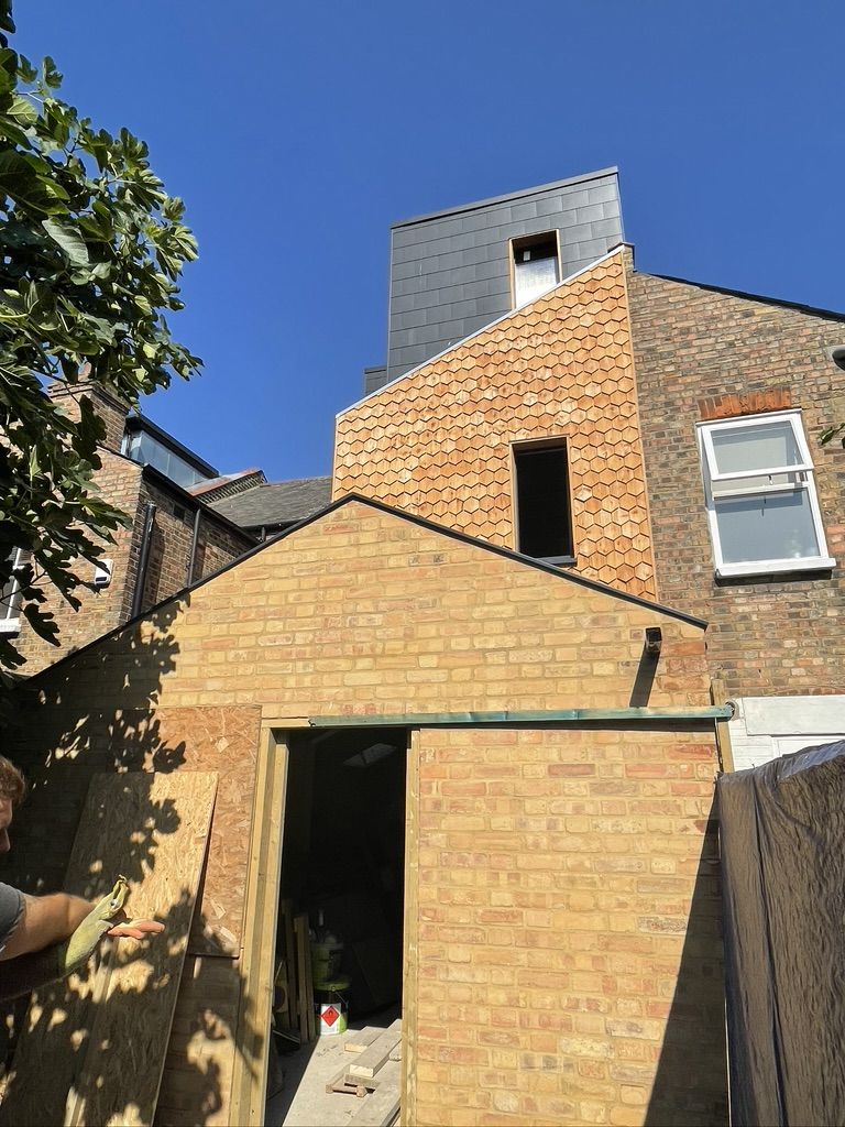 Completed cedar wood cladding on victorian house, with extension and roof conversion