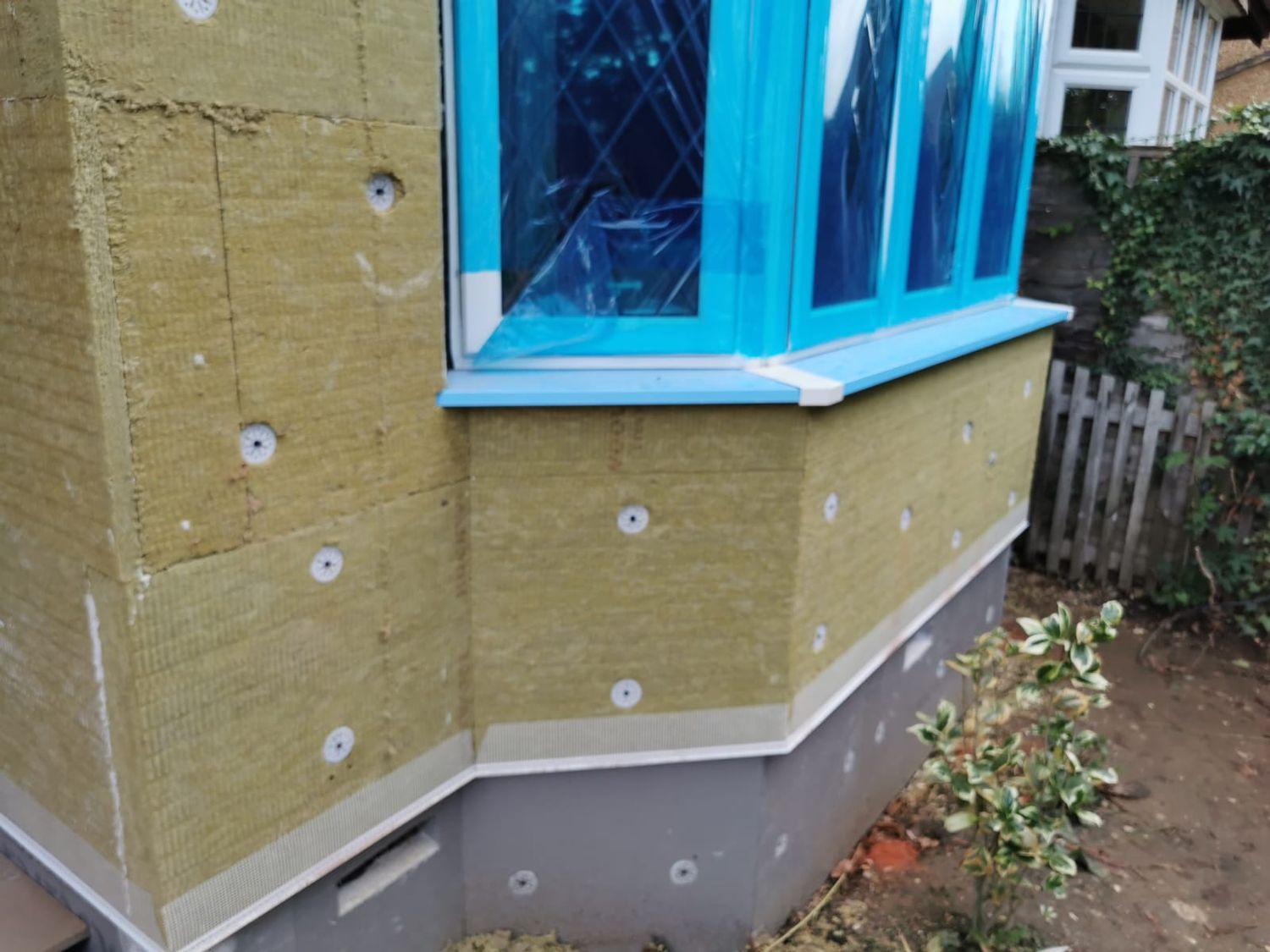 Plinth insulation boards installed around bay window