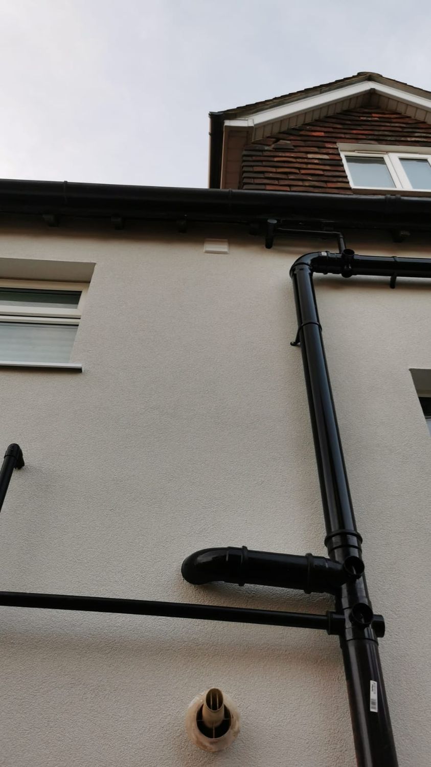 Downpipes re-fitted to new wall level after external wall insulation installed