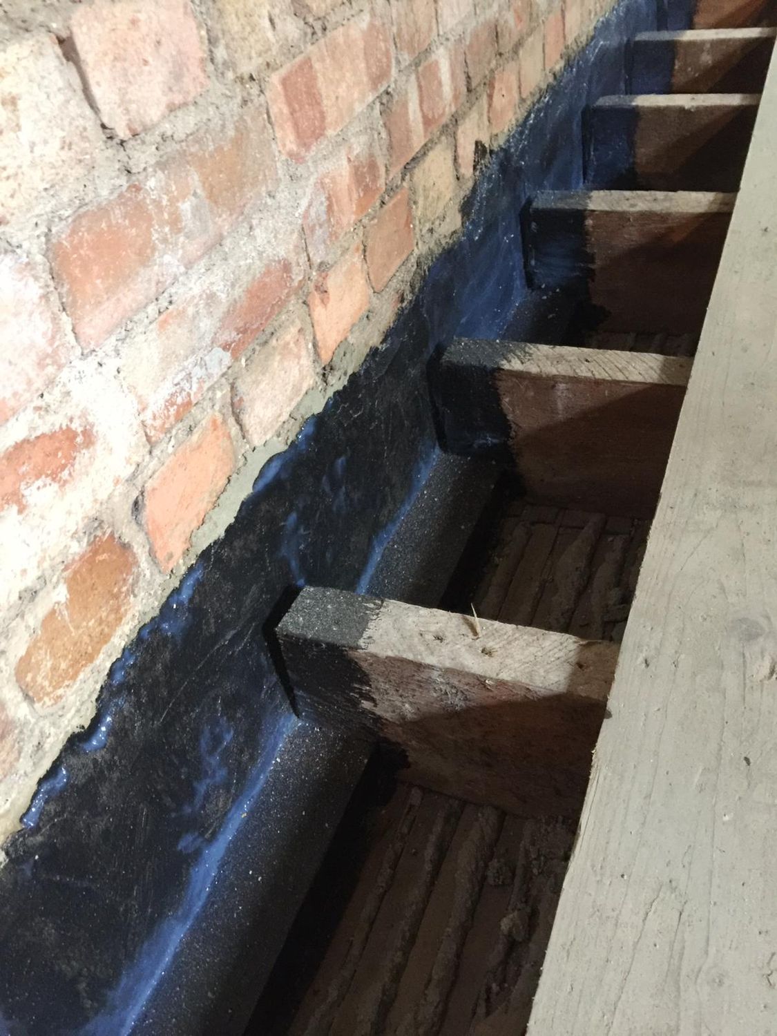 Airtightness work around floor joists using Aerosana Visconn fibre airtight liquid membrane in Muswell Hill, London