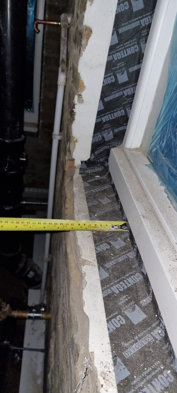 Airtightness taping around window reveal using Pro Clima Contega Solido Exo airtightness tape