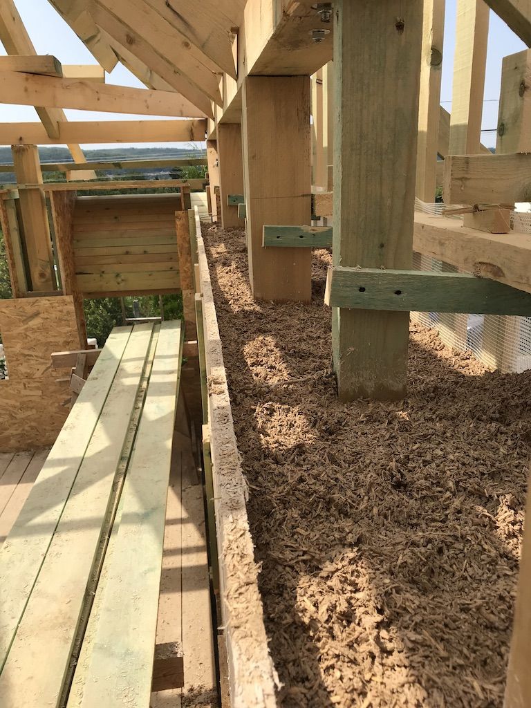 Installing hemp-lime mixture into timber structure