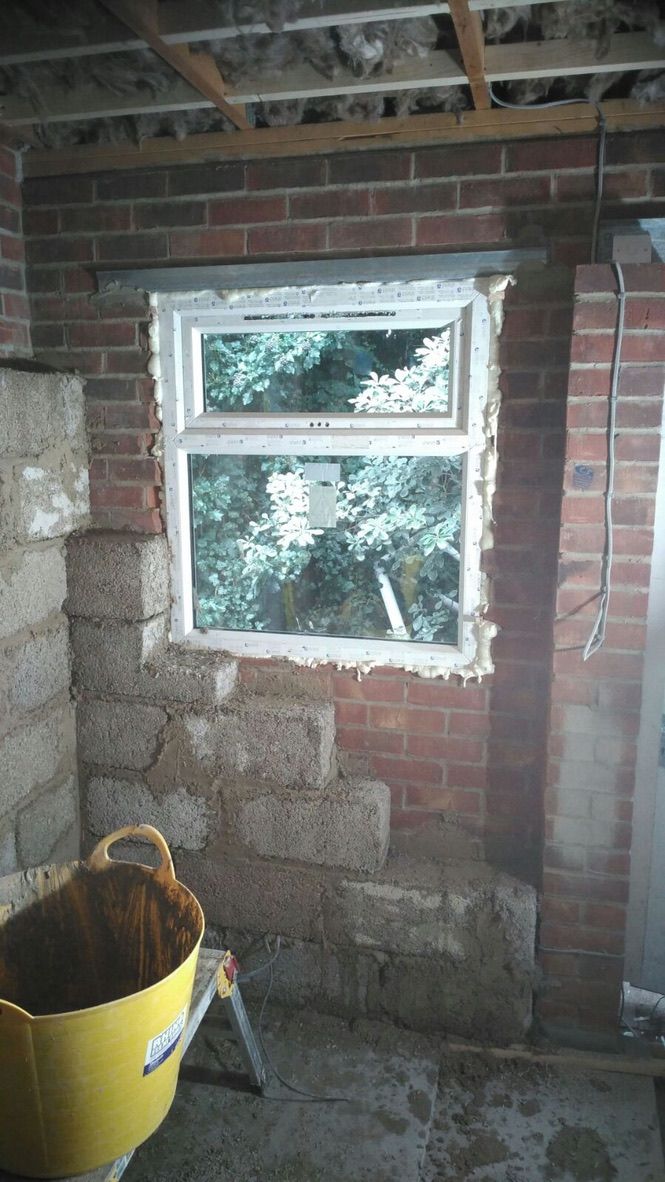 Natural hempcrete blocks being installed internally onto single skin masonry wall