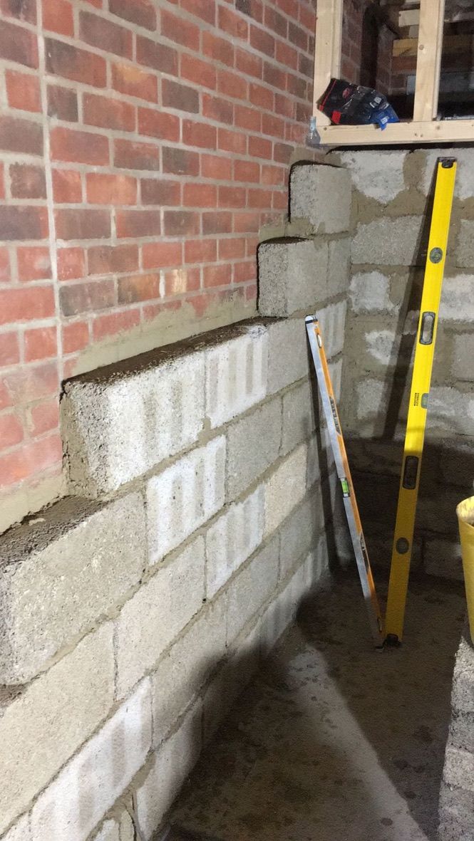 Natural hempcrete blocks being installed internally onto single skin masonry wall