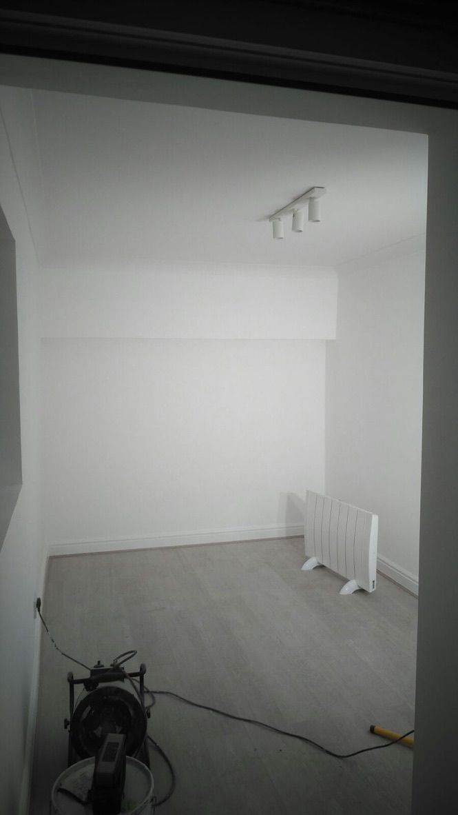 Insulated, lime plastered, painted walls in converted garage room