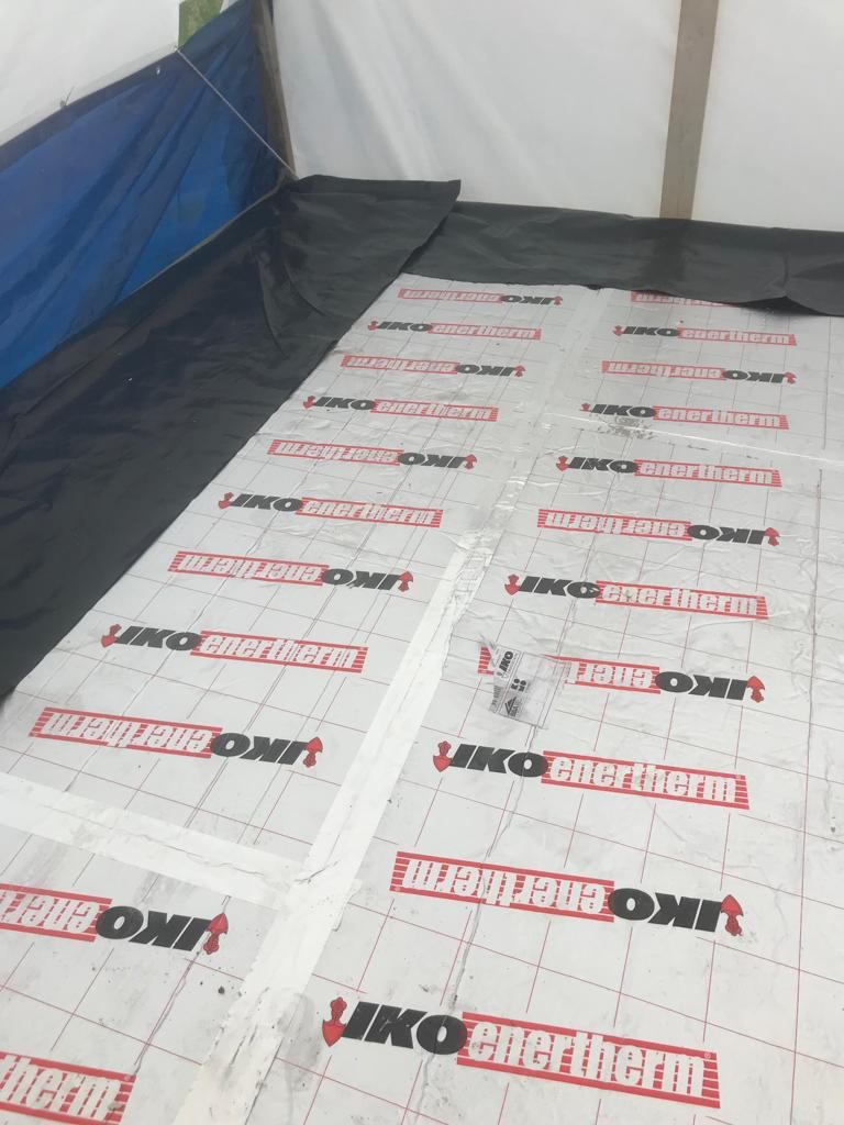 Warm deck flat roof structure, insulation boards being installed