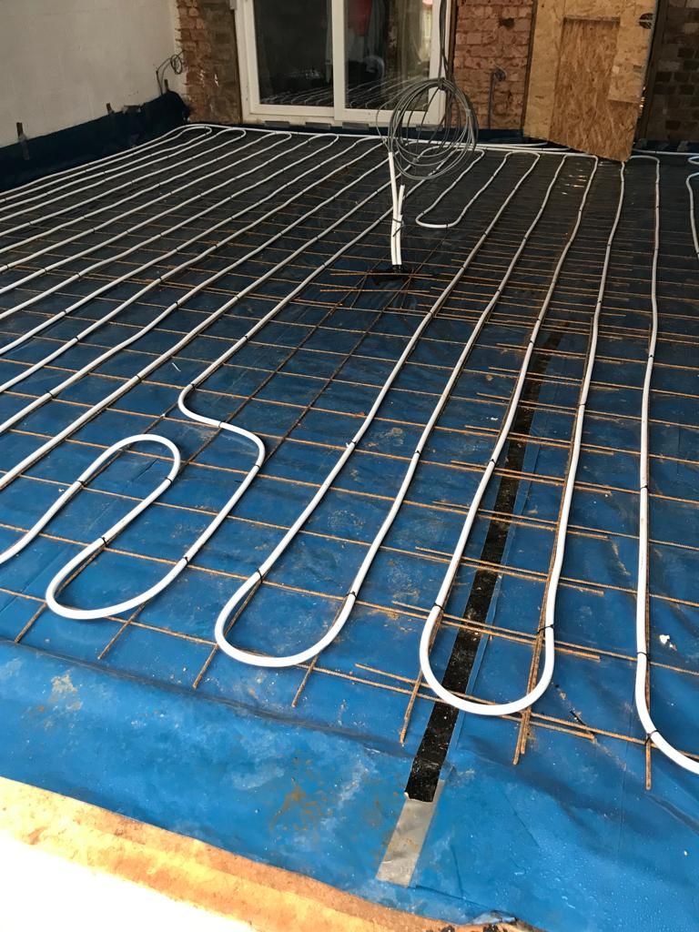 Reinforcing mesh and underfloor heating pipes laid before floor slab