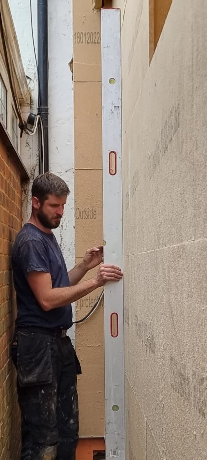 Steico wood fibre external wall insulation boards being installed onto ceramic blocks