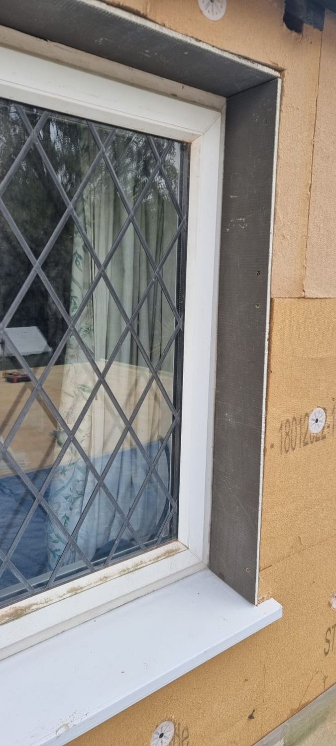 Insulating around window reveals
