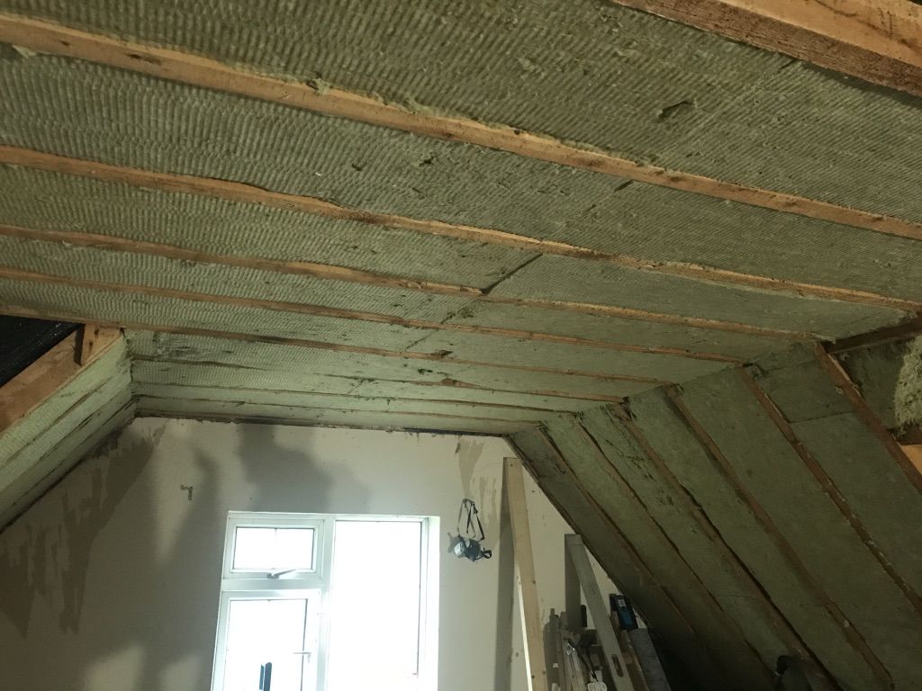 Flexible Rockwool batts installed between rafters in loft ceiling and roof
