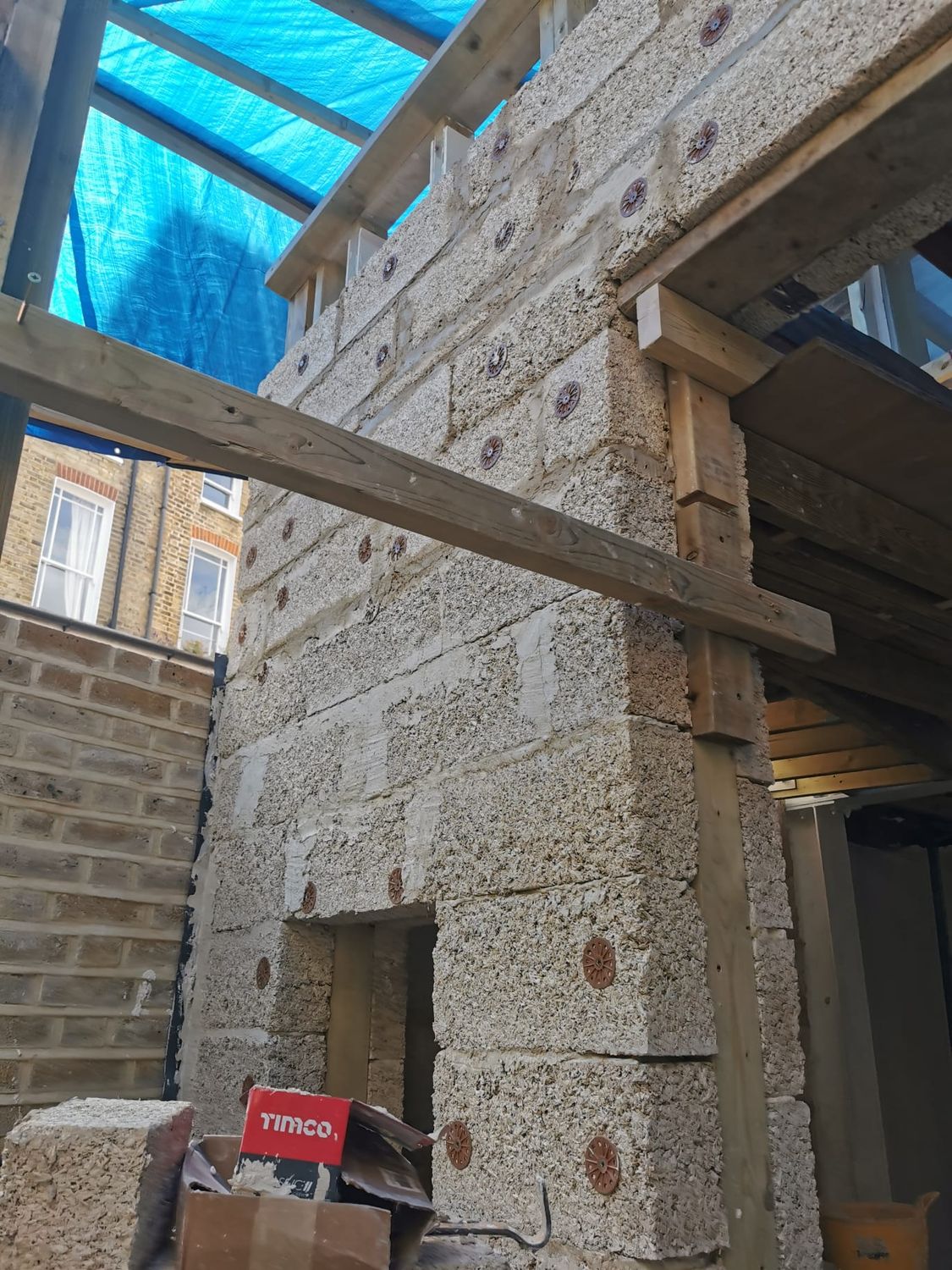 Hempcrete wall goes up in and around timber frame for new extension in Archway