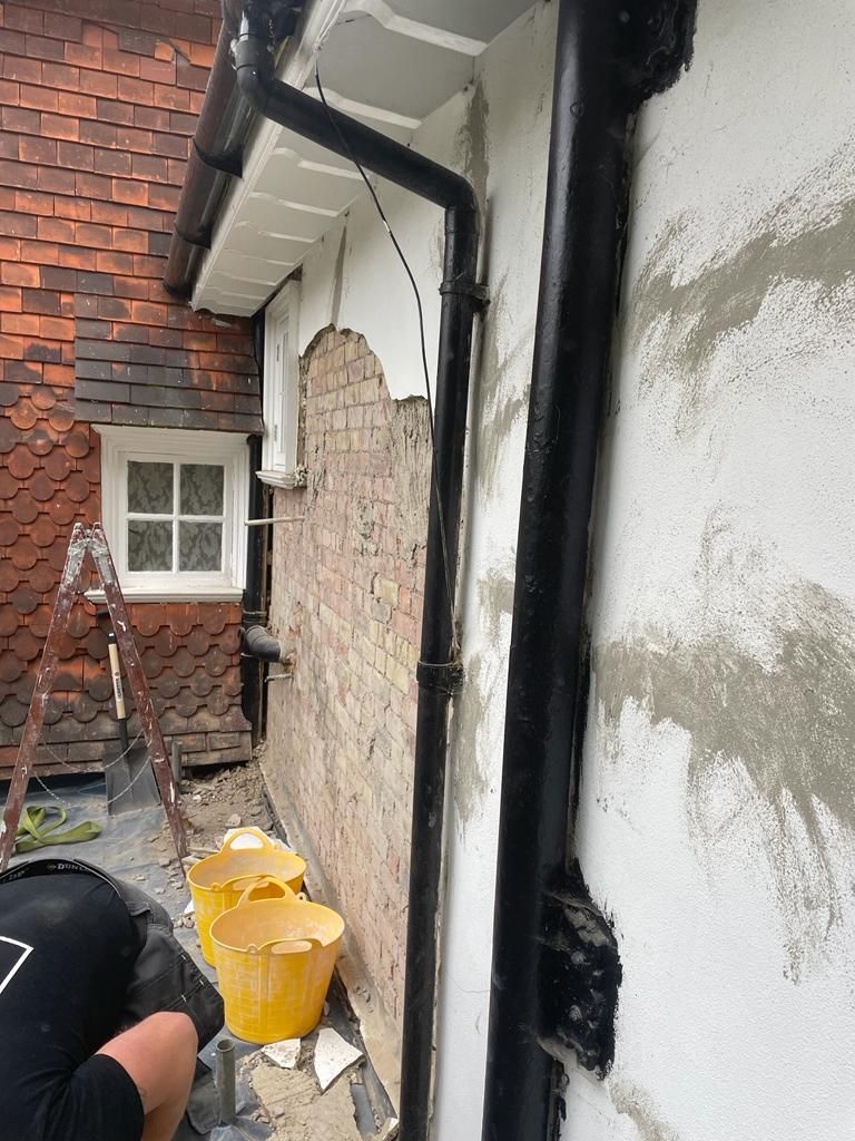 Preparation works - Cementitious, non-breathable render being taken down to bare brickwork before lime rendering