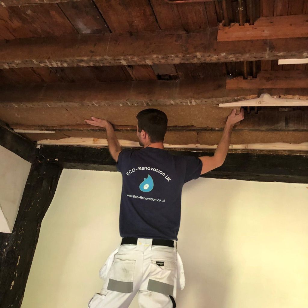 Installing flexible hemp jute batts between ceiling rafters