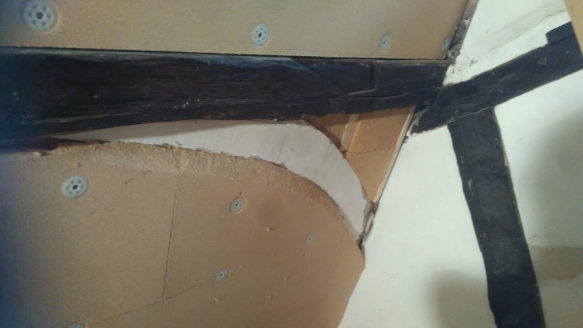 Insulation cut neatly around exposed timber structure